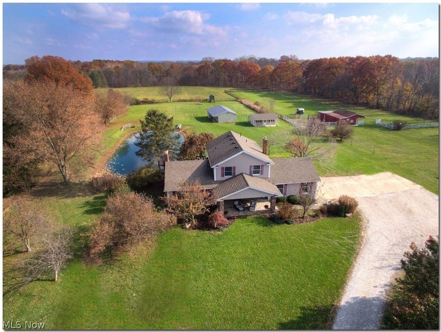 Beautiful home and property, ready for new owners. Nothing to do but move right in! 4 bedrooms, 3 full baths. First floor laundry. Many special features, family room with black walnut flooring, coffered ceiling, ash paneling with sliders overlooking large deck and lake. Large eat-in kitchen with cherry cabinetry, LED lighting, sliders to deck. Formal living room and dining room. New carpet & dishwasher. C/A - 6/2017. Frig - 2015. Furnace, 90% efficient - 2014. Roof 10 years old with 40 year shingles. Basement access thru garage or house with workshop area. 26 x 43 barn with city water (possible horse property). Other outbuilding currently used as an office. Country living with city conveniences! Tied in to city water and sewer. The pictures say it all! One year home warranty for new owners.