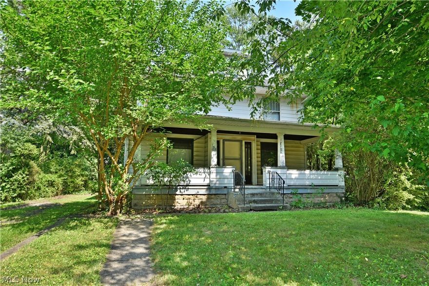 Explore three floors of potential with this ready-to-renovate, three-bedroom Warren home with additional third floor attic space! The home sits in tree veiled privacy on a substantial lot, with an included driveway base and outbuilding foundation for a detached garage. A large, covered front patio spans the front of the home as you make your way inside the front door and through the foyer. Immediately, you’ll take notice of the thick stained woodwork that trims the baseboards and window casings of each room; a theme that continues throughout the home. Hardwood flooring below is easily revived as the expansive living room highlights a brick fireplace with built-in cabinets at the far side. The formal dining area offers its own casements as it traverses into the sizeable kitchen. Secure basement access is joined by separate rear entries to the home here. Upstairs, the winding landing delights with yet more built-in storage as the three bedrooms branch away with additional hardwood floors