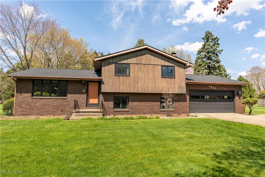 Charming 4-Level Split on a Spacious .72-Acre Lot! This delightful home offers over 1,800 sq ft of bright and versatile living space, brimming with potential and ready for your personal touch. Step into the welcoming great room, filled with natural light from a large picture window and enhanced by an open floor plan perfect for everyday living and entertaining. The eat-in kitchen features ample cabinetry, a classic white tile backsplash, built-in shelving, a breakfast bar, and a cozy dining area with sliding glass doors leading to the enclosed sunroom. You'll love spending time in the sunroom, which boasts vaulted ceilings, skylights, and multiple sliding glass doors that open to a wraparound deck ideal for enjoying peaceful views and warm summer evenings in the spacious backyard. The lower level offers a cozy family room with a stunning floor-to-ceiling stone wood-burning fireplace and live-edge stone shelving. Also on this level is a convenient mudroom/laundry room with garage access, plus a full bath with a walk-in shower. Upstairs, you'll find three bright bedrooms, including one with a charming faux brick accent wall. The full bathroom includes a double-sink vanity, a tub/shower combo, and a linen closet. The basement provides ample storage space to keep everything organized. Don’t miss this opportunity to make this house into your dream home. Schedule your private showing today!