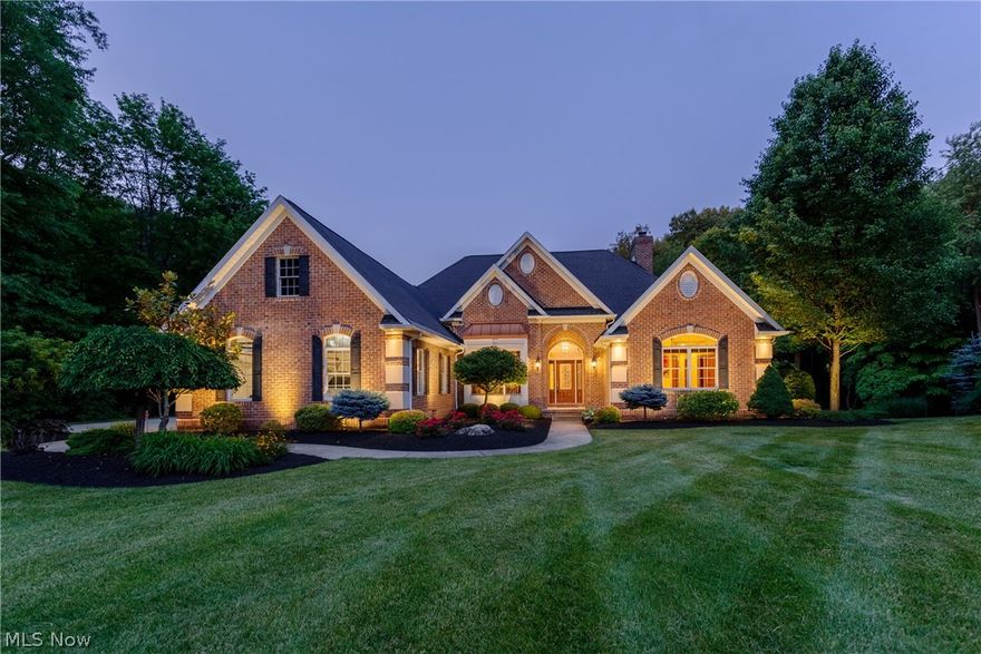 Situated on a serene one acre lot in Green, this stunning raised ranch style home is sure to take your breath away. This home features an open floorplan, a luxurious master suite, and a walk-out lower level that overlooks a pond and peaceful wooded area. All that is missing is you! The cozy living room opens to the spacious kitchen, which boasts granite counters, stainless steel appliances, a sunny eat-in area with a fireplace, and sliding doors to the screened in porch and balcony. The master suite features a sitting area with a fireplace, his and hers walk-in closets, a convenient laundry room, and a gorgeous en suite bath with double vanities, a soaking tub, and a large step-in shower. The formal dining room, two spacious bedrooms, a full bath, and a half bath complete the first floor. The lovely walk-out lower level includes a family/media room, a kitchenette with granite counters and a wine fridge, a second master bedroom with an en suite bath, another bedroom, a full bath, and sl