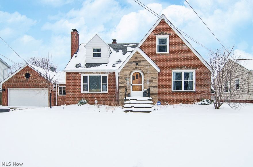 Welcome home to this charming mid-century cape cod located in the heart of Brooklyn Heights (voted one of Cuyahoga County's 2015 Top 5-featured communities due to having the lowest tax rate in the county, the highly acclaimed Cuyahoga Heights Schools, safety, services & accessibility). This home boasts many desirable features, including an open floor plan, updated kitchen (2011: new cabinets, new countertops, new flooring, and newer appliances), remodeled bathroom (2014), and renovated breezeway.  The exposed brick in the kitchen adds an additional level of character not found in many homes in this area. Hardwood flooring covers most of the main level. The finished basement includes a second fireplace and wet bar. This four bedroom home is full of storage; including two walk-in closets on the second level, and two full attics (one on the second level, the other above the garage).  A breezeway connects the home and two-car garage. Step out back onto the newer stamped concrete patio (201