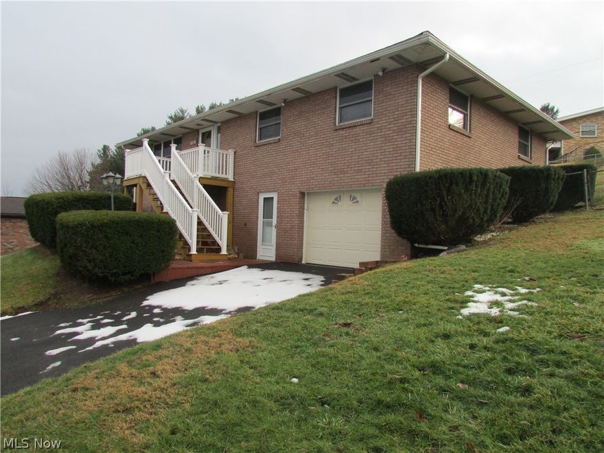 This is a brick ranch with a gorgeous view of the Ohio River.  Property has been updated with laminated flooring throughout, oak kitchen cabinets, walk-in shower, and replacement windows.  Septic system has been approved by the county.  There is a large wrap around deck and patio to the rear.