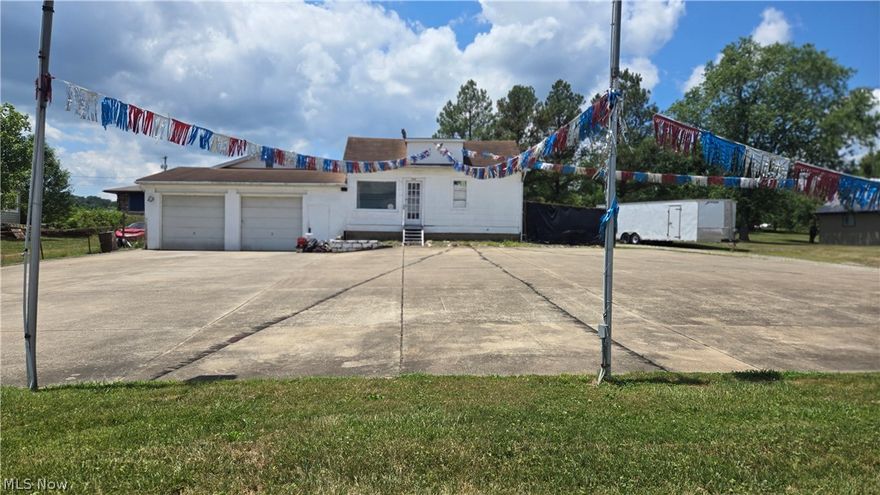 Excellent Traffic area. Opportunity- Building not a drive by- built in three phases (1) original structure 1209 sq ft finished w/ 2 office spaces and half bath. (2) attached front garage area 28x26- heated w 10' ceilings and 2 9' high garage doors. Mohawk heavy duty lift remains (3) back newest area 28x32 with oversized garage doors, heated and half bath. Total finished 2933 sq ft.  Full parking in front is concrete over 5600 sq/ft in excellent condition. Property was a used car lot for numerous years and being sold AS IS - No Warranties--Good TRAFFIC COUNT - on adjacent Dupont Rd. over 11,000 cars per day--On Lubeck Ave /Gihon Rd in property vicinity traffic count over 6000 cars per day. Info from WV. Dept. of Hwys.  Easy access off Rt 95/Dupont Rd at bottom of Gihon Rd Exit (Lubeck Ave) directly across the street!