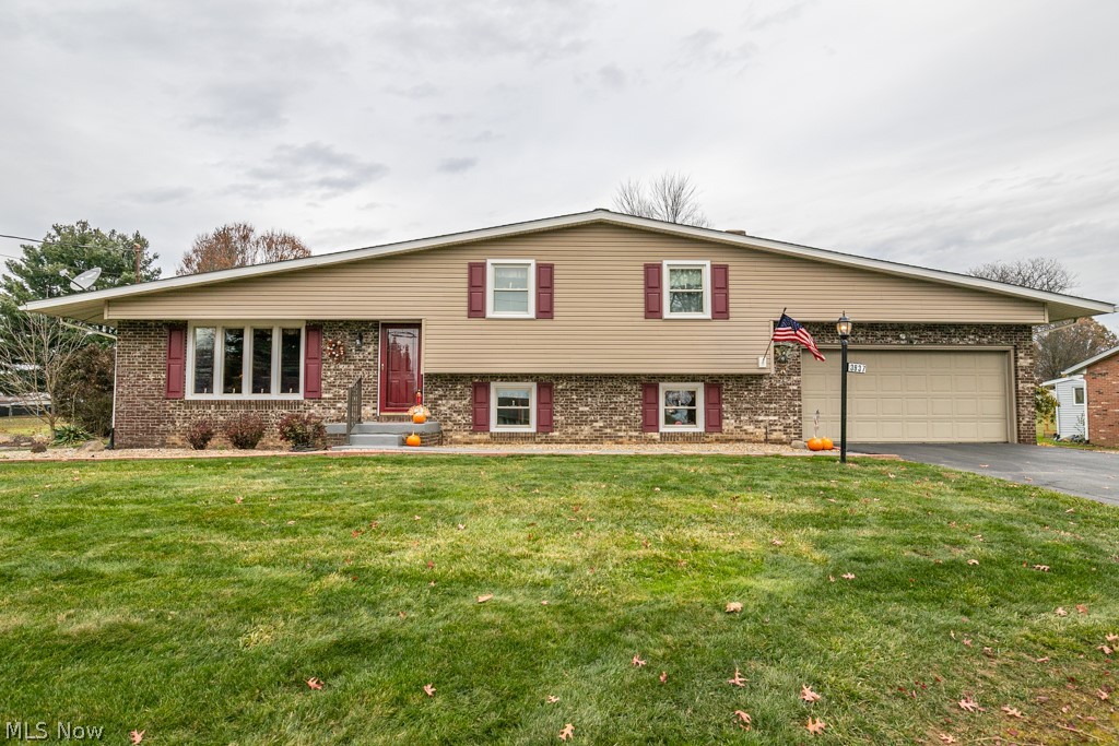 Desirable four level split! This home has a very functional floor plan, with a living room featuring windows with tons of natural light, and a kitchen flowing into a four-season room that can be used year-round! Walk up a few steps to find the master bedroom with a private full bath. Two more bedrooms can be found on the upper level. The the second level includes and very nice living room with a fireplace as well as a half bath. The lower level includes a rec room as well as a laundry room and plenty of storage area. You'll love the easy-to-maintain deck overlooking the land in the backyard. So much room with an amazing yard and in Lake school district!