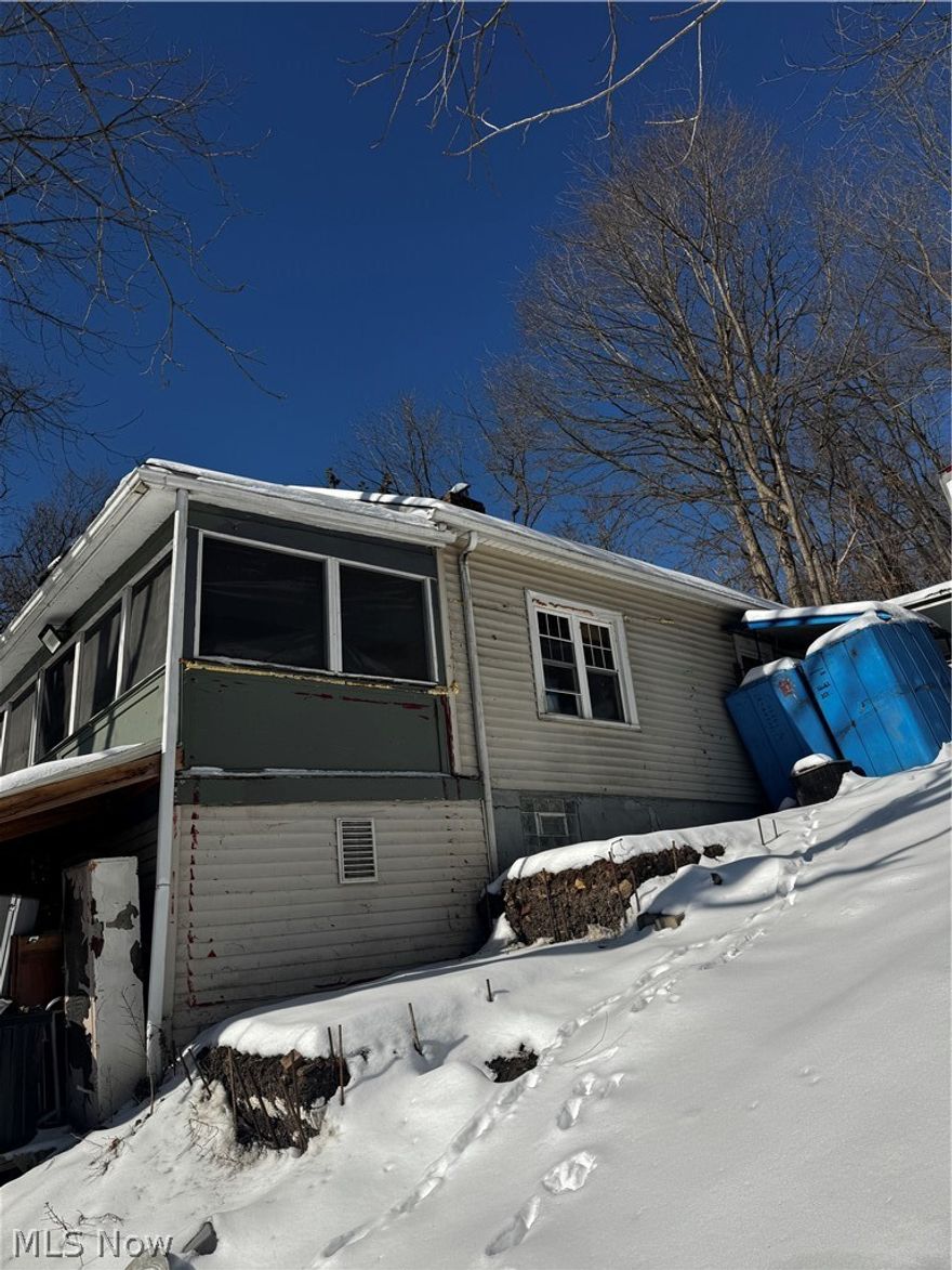 Convenience and potential await! This 2-bedroom, 1-bathroom home in Bridgeport, Ohio is perfectly situated and full of possibilities. Surrounded by trees, it offers a peaceful and private setting. Bring your ideas and your favorite Realtor to see it today! Agents see remarks