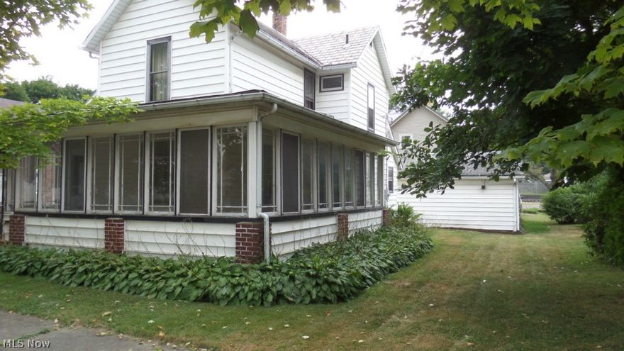 Come see this very nice home on a corner lot in Minerva. Close to downtown on a quiet residential street and walking distance to school, parks and downtown activities. This spacious home has many built-in features and beautiful hardwood floors. The family room has a wood burning fireplace and there is an eye catching chandelier in the formal dining room.  Designed for one floor living, if desired, with a full bath on main floor, half bath is upstairs. The two sided wrap around porch is windowed-in and adds a formal touch to the entry into the home.  Main house has a slate roof, shingles on porch was replaced May 2015.  This home is truly in move in condition. The new owner needs only to add that personal touch to make this an excellent place to call home.