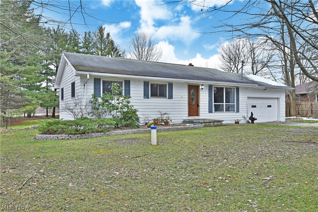 Enjoy two floors of finished living space with a huge, detached 32x26 backyard garage in this move-in-ready home! Offering both big potential and privacy alike, the tree line lot nestles the home with a natural wood line. The concrete driveway leads up to the two-car garage while a walkway extends to the front porch. Step inside the ornate, wooden door to take in the brightly lit living room as natural light filters through the front picture window. Hardwood flooring runs below as it spills into the nearby hall and bedrooms. Nearby, casual eat-in dining looks on into the spacious kitchen as the marble-look countertops pair with natural finish Kraftmaid cabinets and tile look flooring all updated in 2012. It also gives access to the spacious rear deck with composite decking. Down the hall, an updated full bath in 2015 showcases a stylish vanity and sizeable shower surround with tub. The three bedrooms stagger in size, each with personal closet space, overhead ceiling fixtures, and sceni