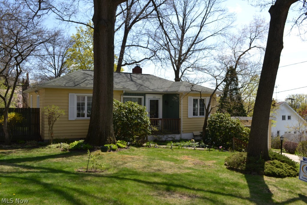 Charming ranch on a park-like double lot! Beautifully updated and absolutely spotless! Updated kitchen w/Aristokraft cabinets. Formal Dining Room. Spacious living Room with picture window. Master bedroom is currently being used as a den and opens onto a quaint patio. Updated Main Bath. First floor features hardwood under the newer carpeting. Walk-out lower level includes a huge third bedroom with double closet, family room with woodburning fireplace and a large utility room which includes a shower, toilet, washer, dryer and utility sink. Walk-out to the relaxing patio and enjoy the gorgeous landscaping on this fully fenced, double lot! Attached, 2 car garage features a newer concrete floor. Updates include the roof, gutters, and downspouts. Newer concrete driveway , patio, and front porch. Newer windows. Updated wiring. Newer A/C and Hot Water Tank. Basement has been waterproofed with a lifetime transferrable warranty. Nothing to do, but move-in and enjoy!