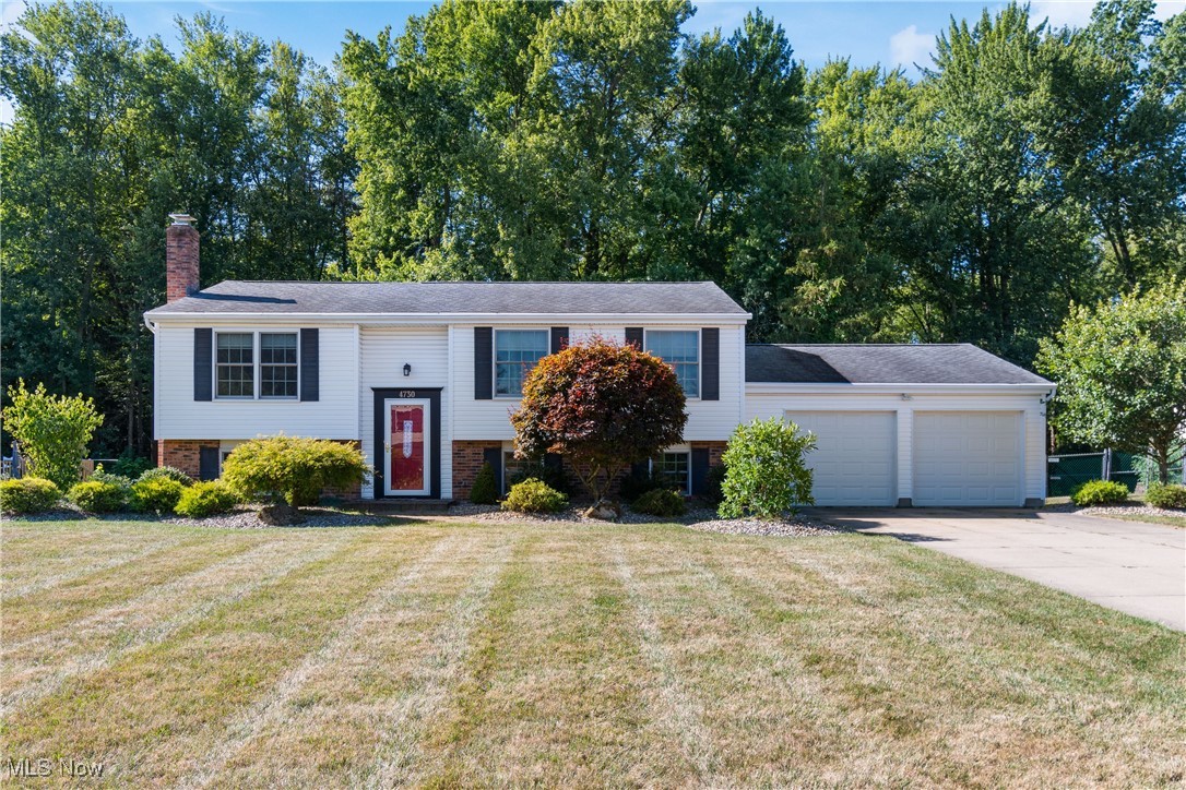 Check out this unique bi-level located in the top rated Green Local School District. This one offers over 2200 sq. ft. with 3 bedrooms, 2.5 baths and a possible 4th bedroom in the finished walk out lower level. As soon as you pull up you will notice the oversized concrete driveway. The original owner completed an addition in 1995 offering a large eat in kitchen with island and a dining area/sunroom with tons of windows overlooking the private back yard and wooded views. The 26x18 living room offers lots of space. Down the hall is 3 bedrooms and 2 full baths. The master has a full master suite with large jetted tub, double sinks and a separate shower with new glass doors. The lower level separates this bi-level from most with a family room with fireplace and a separate room that is 26x20 that could be a 4th bedroom or additional living space. There is also a 24x18 storage room leading to the two car attached garage. Some recent updates include roof/windows 2010, Trane Furnace/AC 2022, and new gutters with gutter guards 2015. This one has so much to offer at this price and will make a great house to call HOME!