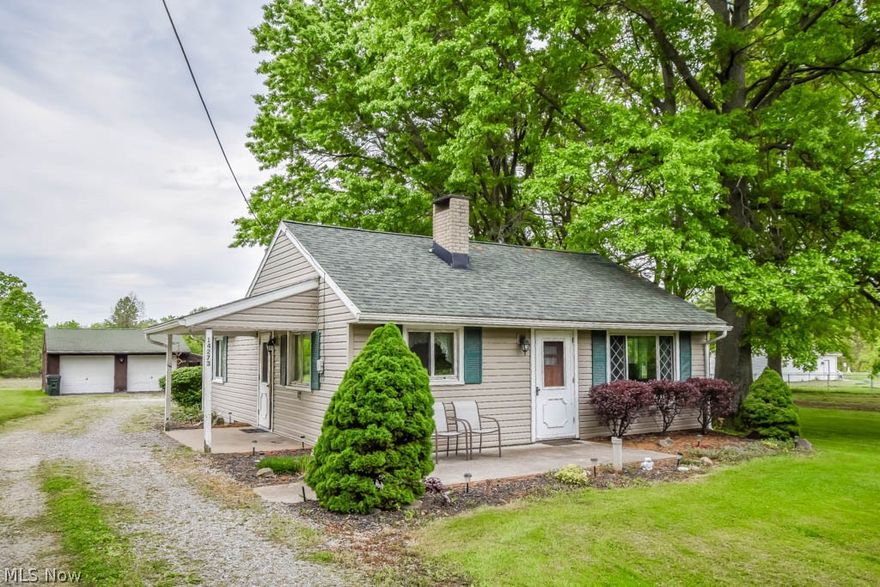 You'll love this cozy two bedroom ranch in Marlington schools! The front patio leads into a warm and inviting living room with knotty pine walls, built-ins, and a wood-burning fireplace. The charming kitchen is well equipped and has a dining space, plus access to a handy mudroom with a sink and shower. Nearby, a convenient laundry room offers extra storage. Both bedrooms are nice sized and share an updated full bath. Outside, enjoy a peaceful half-acre lot, a two-car detached garage, and an attached shed for your outdoor belongings. If you're looking for true one floor living and a beautiful country setting, this is it! Call today!