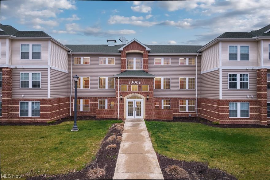 Welcome to this gorgeous, never been lived in condominium in Charming Olmsted Falls! Conveniently located just around the corner from the elevator, this like new 1 bedroom + Den/Office is the perfect place to call home.  Walk into the bright open floor plan with beautiful, wide plank, luxury vinyl flooring throughout the entire unit. The brand-new kitchen has plenty of soft close cabinetry, quartz counter tops, tile backsplash, and brand new Frigidaire appliance package. Convenient in unit laundry room has additional cabinet space for storage.  Enjoy the additional office/den space with custom designed millwork perfect for a home office or could easily be transformed into a guest space. The main living area has sliding glass doors that lead to the private covered balcony and provides the perfect outdoor living space. All new lighting, plumbing, and door fixtures throughout.  The stunning main bath conveniently connects to the primary bedroom and has a large vanity and walk-in shower with glass doors and tile surround.  The spacious primary bedroom has a large walk-in closet for plenty of storage.  This building was built in 2020 making all the mechanicals newer!  This unit comes with one private garage space with opener located just behind the building. Don't miss your opportunity to own this stunning, practically brand new home!