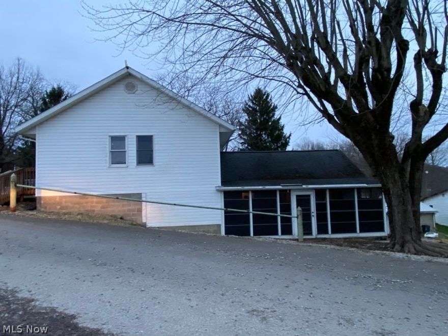 This home is the perfect starter home or or get-away for some lake fun or local recreation. This 1272 sq. ft. home features a large family room addition that includes a beautiful gas fireplace, vaulted ceiling and bay window. The main level includes a 3 season entry way, the living room, eat-in kitchen with gas range, 2 bedrooms, bathroom and a room that can be used as office space or entry way from the rear of the house.  The 220 sq. ft. basement is under the original home and includes the laundry area, double sink, shower, furnace, gas hot water tank, and gas wall heater. The adjoining lot houses a 14' X 20' single car garage. Behind the house is a 16' x 20' "Summer Kitchen".  This building is open concept with a dry sink, a loft and covered porch the width of the building.