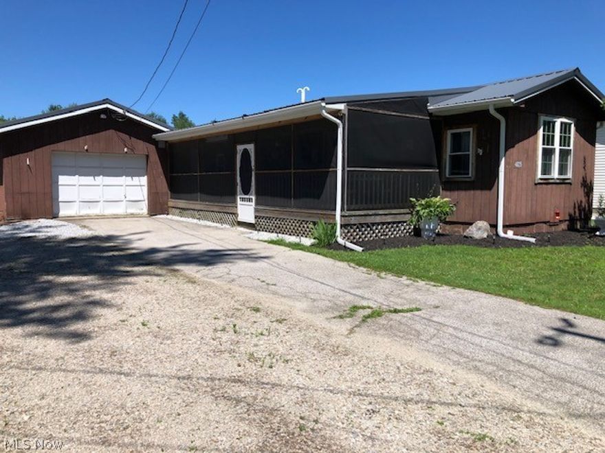 Wow! Your perfect get-away or full time home close to the strip at Geneva-On-The-Lake and Lake Erie for under 100K.  Enjoy peace and quite on the large screened in porch or relax around the fire pit in the back yard. All the work has been done.  New Landscaping, new paint on porch and home, All new gutters on home and garage.  Comes completely furnished with New Stove, Refrigerator, and microwave. Cute as a button. All of this plus a 1 car detached garage.  (Please note there is an annual mobile home tax separate from the property tax )