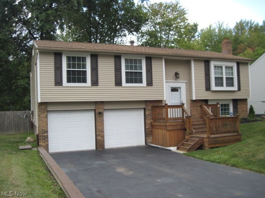 This beautifully updated home can now be yours. Updates include New flooring throughout, Updated Kitchen with stainless steel appliances, and  updated bathrooms, Exterior Vinyl Siding, Windows, Entry Doors, Deck, and Roof. The family room has a white washed fireplace and new flooring with a half bath and sliding glass doors to access the Private wooded fenced in back yard. The Garage has new Insulated Garage doors and is waterproofed with a transferable warranty. Call for your appointment today !