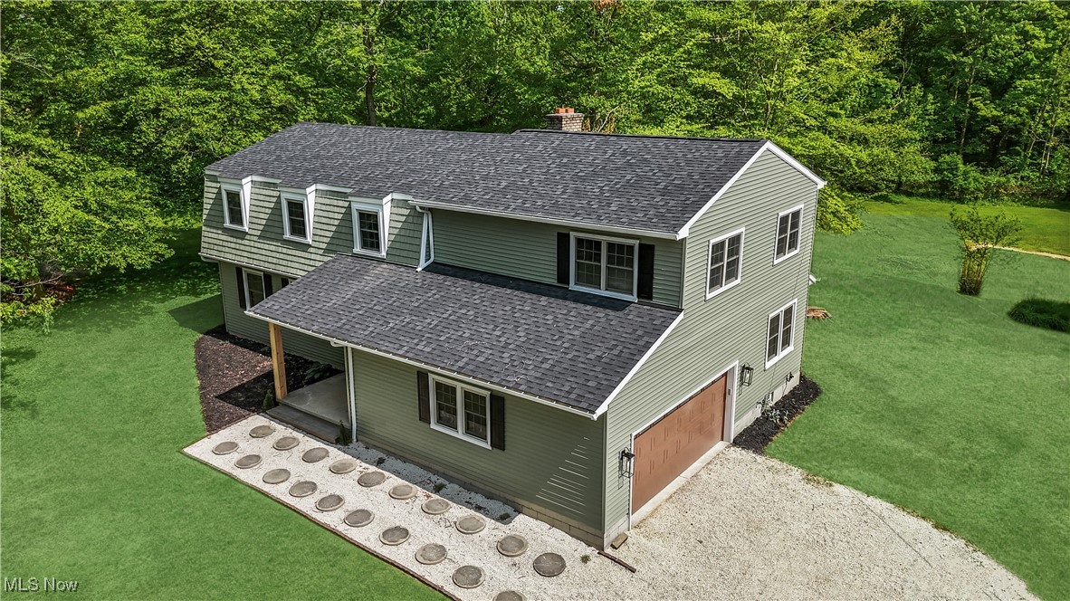 If you've been dreaming of peace & privacy without sacrificing convenience, this beautifully remodeled home is your perfect escape. Tucked a quarter-mile off the road on 5 scenic acres with a pond, this property offers the tranquility of country living while keeping you close to all local amenities, notably less than 10 minutes to Medina Square.
Every inch of this home has been thoughtfully updated with today's modern finishes. The exterior boasts a brand-new roof, front walkway, stylish front door & new garage door & all new siding. Step inside & be greeted by a welcoming foyer that opens to a bright living room & stunning kitchen.
The kitchen is an entertainer's dream, featuring brand-new stainless steel appliances, quartz countertops, a spacious 9-foot island, modern shaker cabinets, & a designer tile backsplash, & the dinette has access to the back patio. Just off the kitchen, you'll find a convenient half bath & a cozy family room with access to your private backyard & peaceful wooded views.
Upstairs, two generously sized bedrooms share a beautifully updated full bath with new vanities, fixtures, & a stylish tile shower/tub surround. The third bedroom includes its own ensuite with a walk in tile shower & contemporary finishes. The luxurious master suite is a true retreat, complete with vaulted ceilings, large windows overlooking the property, a massive walk-in closet with custom built-ins, & a spa-like ensuite featuring a double vanity & a stunning walk-in tile shower.
Virtually everything in this home is brand new - flooring, carpet, paint, lighting, hardware & fixtures, interior doors, furnace, hot water tank, & electrical panels. The finished basement adds even more flexibility with a spacious rec room, laundry area, & a large workshop/storage room with direct access to the backyard.
This property is a rare blend of modern living & natural beauty. Don't miss your chance to own your own private retreat!