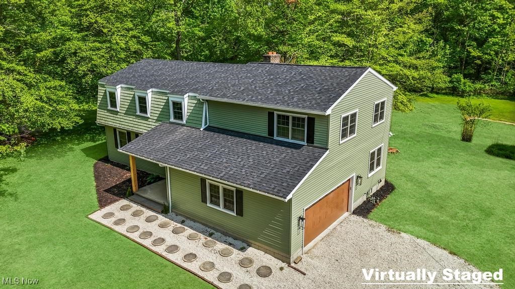 If you've been dreaming of peace & privacy without sacrificing convenience, this beautifully remodeled home is your perfect escape. Tucked a quarter-mile off the road on 5 scenic acres with a pond, this property offers the tranquility of country living while keeping you close to all local amenities, notably less than 10 minutes to Medina Square.
Every inch of this home has been thoughtfully updated with today's modern finishes. The exterior boasts a brand-new roof, front walkway, stylish front door & new garage door & all new siding. Step inside & be greeted by a welcoming foyer that opens to a bright living room & stunning kitchen.
The kitchen is an entertainer's dream, featuring brand-new stainless steel appliances, quartz countertops, a spacious 9-foot island, modern shaker cabinets, & a designer tile backsplash, & the dinette has access to the back patio. Just off the kitchen, you'll find a convenient half bath & a cozy family room with access to your private backyard & peaceful wooded views.
Upstairs, two generously sized bedrooms share a beautifully updated full bath with new vanities, fixtures, & a stylish tile shower/tub surround. The third bedroom includes its own ensuite with a walk in tile shower & contemporary finishes. The luxurious master suite is a true retreat, complete with vaulted ceilings, large windows overlooking the property, a massive walk-in closet with custom built-ins, & a spa-like ensuite featuring a double vanity & a stunning walk-in tile shower.
Virtually everything in this home is brand new - flooring, carpet, paint, lighting, hardware & fixtures, interior doors, furnace, hot water tank, & electrical panels. The finished basement adds even more flexibility with a spacious rec room, laundry area, & a large workshop/storage room with direct access to the backyard.
This property is a rare blend of modern living & natural beauty. Don't miss your chance to own your own private retreat!