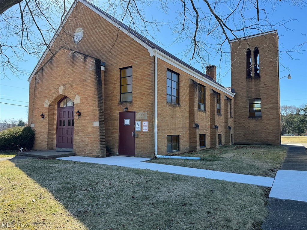 Well-maintained all-brick building built in 1953 with 2,196 sq ft. The former church features a main level 49’ x 32’ free-span sanctuary/worship room with a cathedral-beamed ceiling and mezzanine/choir loft, office, and storage room. The lower level has a spacious gathering/occasion room, a full kitchen, and two restrooms. Mobility elevator between the main and lower levels. Updated metal roof, 2 gas F/A furnaces, and central A/C. The building sits on a nice level 0.98 acres. Well and Sewer. Conveniently located minutes from SR 800, in the heart of Sandyville between Dover and Canton. Zoned R-2— Parcel #53-00921-000. The building has been well maintained and is in excellent condition. Many Possibilities for this solid building.