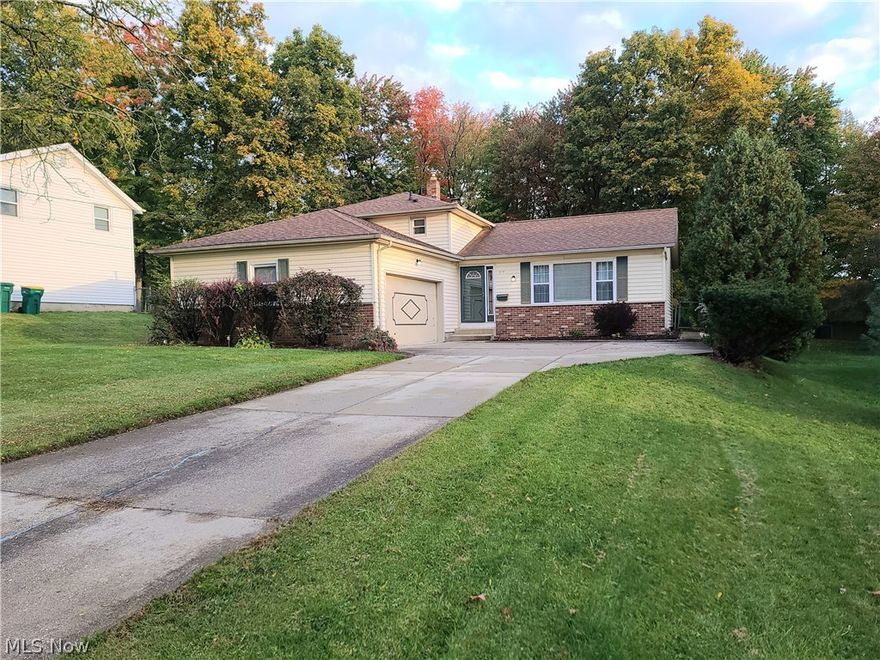 Welcome to 1849 Laurel Drive in beautiful Twinsburg Ohio. This home features 3 beds and 1.5 baths.  As you enter the split level ranch home, step inside to the hardwood entry.  Large carpeted living room with lots of natural lighting from the large bay window.  Dining room with hardwood flooring and sliding door that walks out to the wood patio and large backyard for all outdoor family events. Just the right size eat-in-kitchen that has views of the  family room on the lower level.  The family rooms long brick wall has a new gas fireplace as the accent piece to this space, keeping you warm and cozy in the months ahead.  Just off of the family room you have a large utility room or laundry room.  Half bath is just before you walk out into the 2 car garage with plenty of storage shelves.  The upstairs has 3 bedrooms that have all been updated with luxury vinyl tile floor and new baseboard trim for a more modern look.  Other items in the home that have been done recently or last few years