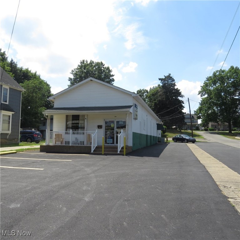 A great office space available in the heart of downtown Mogadore that offers limitless opportunities. This versatile space features a well-appointed lobby that seamlessly opens into a workspace or cubicle area, perfect for employees. Down the hall, you'll find two large private offices. Towards the back of the building, there's a flexible area that could be utilized for additional cubicles, offices, or storage. The space also includes a good-sized conference room, two bathrooms, and a utility room. For added convenience, there's also a side entrance. Recent updates to the property include a newly re-done parking lot and Nature Stone added to the front entrance, enhancing its curb appeal. Given Mogadore's current expansion phase, this location presents a prime opportunity for various businesses, whether for office use or retail.
