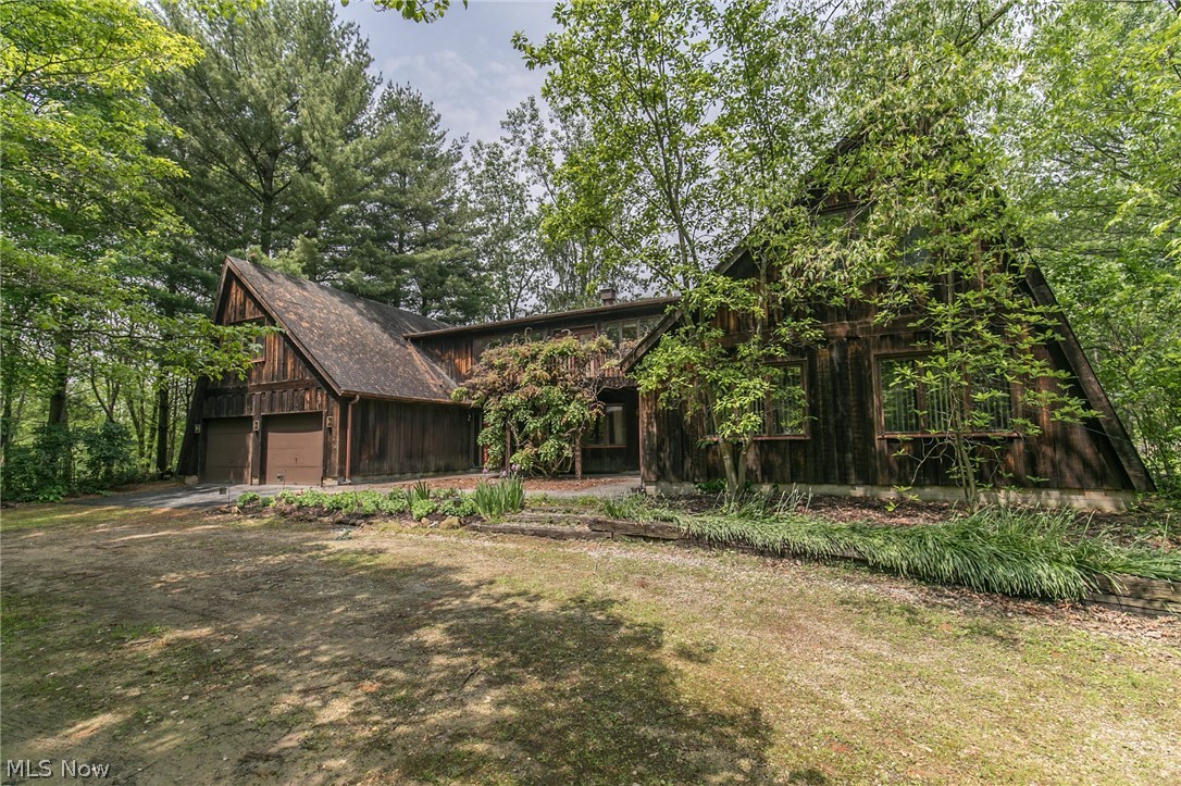 This Open Concept 3,540 sq. ft. 3-4 Bed,2 Bath home designed in the Romantic Style on 5 wooded acres is filled w/ amazing possibilities (described in the seller's words available from your realtor, along w/ room sizes & descriptions). When you drive down the winding drive thru the woods, you are immediately transported from hustle & bustle to a life surrounded by the best nature has to offer, including tranquility & peace. The home incorporates the surrounding Nature into its very heart, integrating Nature’s forms & textures both outside & inside to create a warm, cozy, but open sense of welcome & of refuge from the stresses of daily life. The naturally lit interior is designed for people who are curious & nature-loving... a home like no other. From large maps on some walls to various studio & performance/activity areas, the home is a playground... as is the land: woods to explore, a sports field, tennis court, horseshoe pit, fire pit/picnic areas, & a backyard stone patio. A self-sust