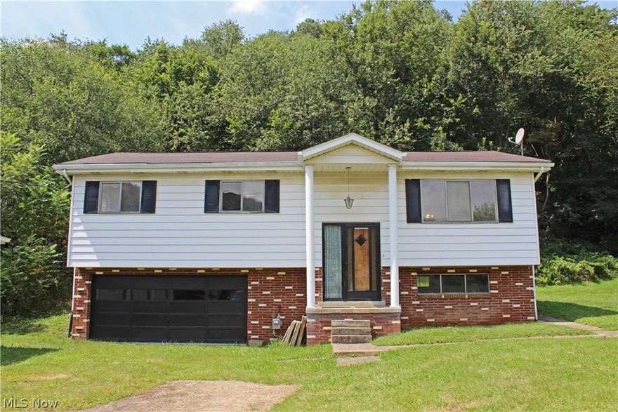 Need storage space?  This well built 3 bedroom, 1 bath home has a 2 car integral garage plus a detached 3 car garage! Beautiful country setting, minutes from Tomlinson Run State Park, and situated on 1.24 acres. Home Warranty included!  Call today!