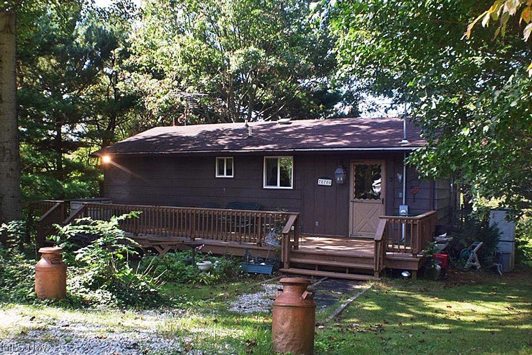 Private, peaceful serenity abides on this wooded .81 acre lot! The main level offers a kitchen with all appliances & pantry, spacious dining room, master bedroom with full, private bath, & well lit living room with slider leading to large back deck. The finished, walk-out lower level doubles the square footage with 3 additional bedrooms, full bath, and utility area. Updated roof & windows. Words cannot convey the extent of tranquility & privacy in this setting. Must see for yourself! Enjoy the amenities of Clendening Lake & surrounding nature.