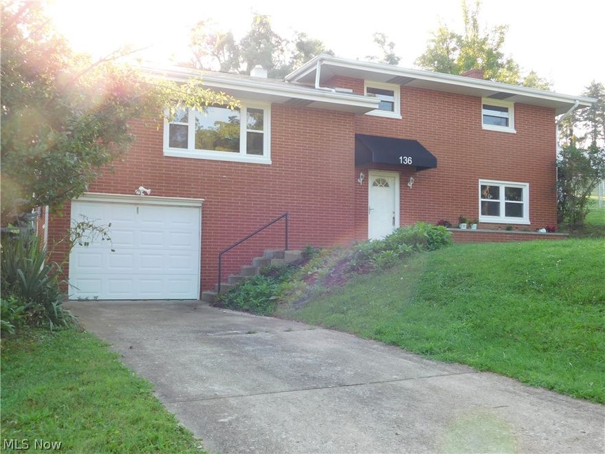 Remodeled house. Every room in the house has been made like new. Every window in the house has been replaced. Walk in the front door and there is a beautiful foyer with a large double closet. To your right is a family room with a glass door welcoming you in. There is a Franklin gas stove that is so inviting. New flooring to complete the room. A large laundry room is next to the family room. 
Upstairs is a large living room with refinished hardwood floors. Every room with hardwoods have been refinished. Large picture window and a trayed ceiling with overhead lighting built in. The opening with a counter and three lights accentuate brings you into the kitchen. Beautiful white cabinets and granite counter tops. The kitchen door takes you out to a very large patio and a outstanding back yard. Great for privacy or entertaining. 
Upstairs you will find a totally remodeled bathroom. Every thing in there from flooring, sinks, commode with a book rack. The book rack comes out for access to th