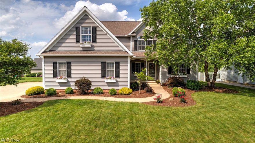 GORGEOUS home in sought after Quail Highlands development within minutes to schools, shopping, parks and bike trail! Very unique home with fabulous updates throughout AND first floor master suite! Two story great room w/fireplace surrounded by large windows with a beautiful view of the backyard! Custom built in bench seats (on either side of fireplace) in great room add additional seating and/or storage.  Fabulous hardwood floors throughout the first floor of the home! Open floor plan with great room flowing into spacious kitchen!  This kitchen has all the bells and whistles--white bright cabinets, granite counter-tops, stainless steel appliances, corner built in hutch, center island, eat in area w/sliding door to deck and backyard! Formal dining room w/beautiful decorative columns! Large first floor master w/walk in closet, sliding door to private deck, master bath w/separate vanities, garden tub w/jets! Upstairs are three bedrooms w/walk in closets, built-ins and some have skylights!