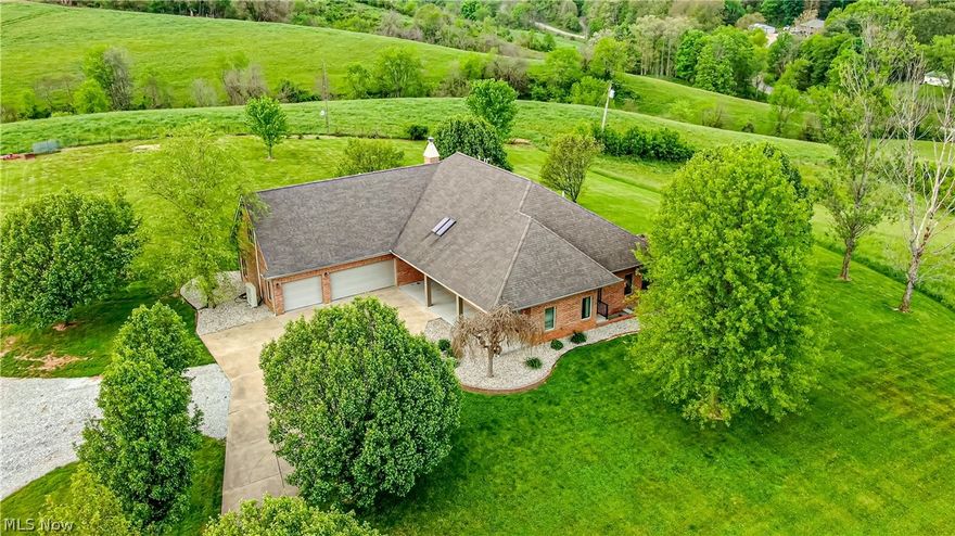 TOWN and COUNTRY one floor lifestyle home offers a 12 acre setting of lush grounds, FREE GAS, and stocked pond. Inviting tree lined drive leads to all brick construction with modern efficient updates. Large open rooms feature views of the countryside that are complimented by oversized windows, hardwood flooring and volume ceilings. The fireside Great Room is the center of the home that opens to kitchen with eating bay, 20x15 owners wing, three additional bedrooms, five full and two half baths, loft style game room, new laundry room and well planned storage. Unfinished lower level offers the potential of additional living space. Recently completed 30x30 detached two car garage with 10 ft ceilings and floored attic. OTHER NEW ADDITIONS:  HVAC Units, kitchen appliances, bedroom carpets, security system, hot water tank, interior painting and landscaping. The protection of a HOME WARRANTY