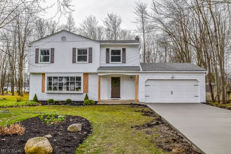 Breathtaking home fit for a magazine! Completely remodeled 5 bedroom 2-story with a clean, rustic style! A brand new driveway leads you up to the front porch with natural wood pillars and matching shutters. Step inside and marvel at the gorgeous dark bamboo flooring throughout the main level. The living room boasts an 11-foot window with seating. Grid board and batten wall accents in the living and dining room. A kitchen to inspire! Featuring granite countertops, stainless steel appliances, subway tile backsplash, new white cabinets, recessed lighting, a pantry and a breakfast bar with shiplap accents. Gather around the beautifully painted brick fireplace with a natural wood mantle set against a shiplap wall! In this room, you’ll love the beautiful wood beams highlighted by natural light from the sliding glass doors. Updated half bath on the main level. Laundry chute in the kitchen and at the top of the steps. Upstairs, the master suite includes a large closet and a stunning sliding ba