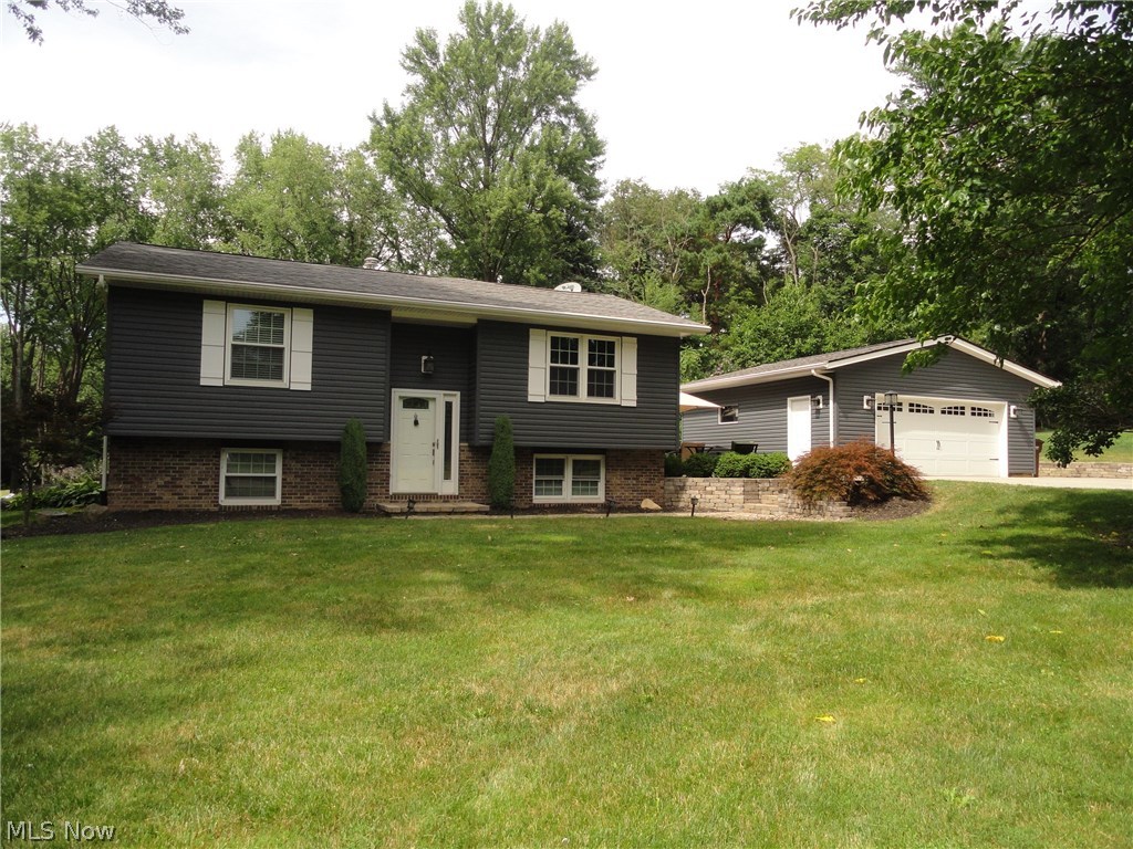 Situated toward the end of Perry Rd near the cul de sac is this beautifully maintained and updated home. Extensive renovations including a 25 x 16 family room / kitchen addition that has a beamed cathedral ceiling, gas fireplace, extra large windows bringing in the sunlight and bamboo wood floors that continue throughout and into the formal living room. The kitchen has beautiful wood cabinets, granite counters, high end stainless appliances, spacious dining area plus a large breakfast bar. The main level has two bedrooms plus a full bath and the lower level has two more bedrooms with another full bath. Plus there is a large finished rec room plus an additional 400 sq ft basement or second rec room as part of the addition and it walks out to the side yard. Sharp curb appeal with leaded glass door, nicely landscaped including a paver patio and fire pit, newer vinyl siding, new roof in 2012, a 2.5 car garage with a double concrete driveway offering plenty of room to park or play. Must se