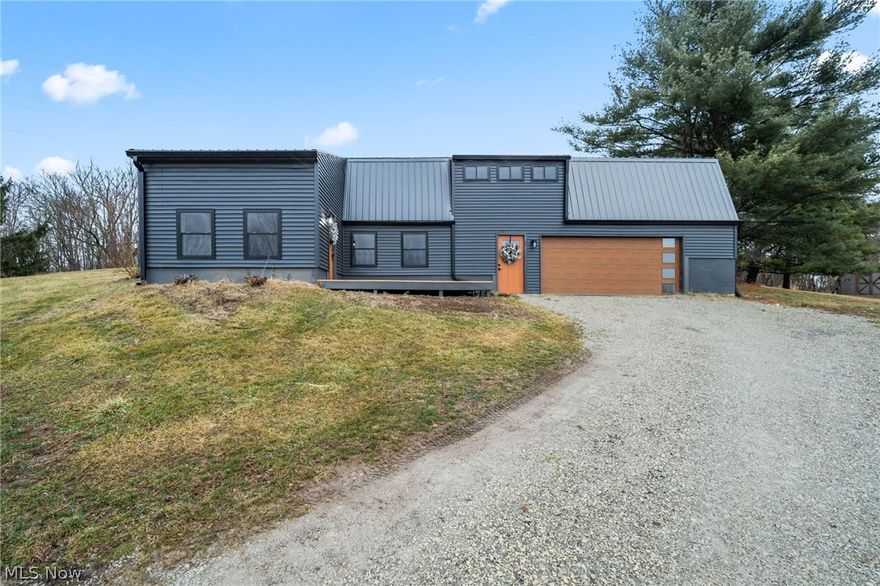 Completely transformed from top to bottom, this beautifully updated home on 1.29 acres blends modern design with everyday functionality. Step inside to discover a custom kitchen featuring brand-new butcher block countertops, a live-edge breakfast bar, and matching open shelving--perfect for entertaining or casual mornings at home. Waterproof laminate flooring throughout the main living areas, complemented by plush new carpet in the bedrooms and on the stairs. Both bathrooms have been fully redesigned with contemporary tile, modern vanities and LED-backlit mirrors. A newly added second-floor laundry adds convenience right where you need it most. Throughout the home, enjoy upgraded electrical with new outlets and switches, LED can lighting, and stylish industrial fixtures. Major exterior updates include a brand-new roof, charcoal vinyl siding, energy-efficient windows and doors, fresh paint, and newly constructed decks for outdoor living. Additional improvements include a new garage door with modern window design, new garage opener, mini-split heating and cooling upstairs, and a brand-new hot water tank. Move-in ready with thoughtful upgrades inside and out--this home offers the perfect blend of style, comfort, and peace of mind. Schedule your private showing today!