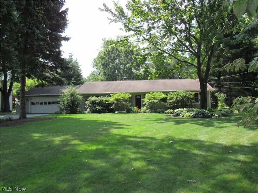 Secluded Mentor updated Ranch features 3BR, 2 full baths including a full master suite with beautiful, custom tiled shower!  Fabulous location in highly desirable area off Little Mountain Rd., within minutes to shopping, restaurants, grocery & yet it is nestled in a parklike setting for privacy!  Big picture window in the living room views some of the mature shade trees.  Slider off of the dining room to access the rear patio.  This home features beautiful hardwood floors in the foyer, DR, and hallway.  Eat-in kitchen has custom ceramic tiled floor (butcher block is negotiable).  Newer flooring throughout!  All appliances are staying including washer & dryer.  Second full bathroom has custom tile & double sinks.  Enjoy the peace & tranquility of the spacious yard from the screened in rear porch (sun rm) or from the patio with the sunsetter retractable awning!  You have the feel of country living, yet you are so close to everything!  There is a two car attached garage & resurfaced drive