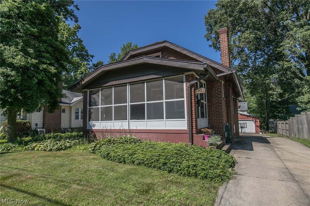 This lovely brick bungalow is to not be missed! Take a look at the charming fireplace with built-in shelving in the family room! Enjoy a cup of coffee on the screened in front porch or walk out the back basement door to a gorgeous patio! Hardwood floors throughout the first floor, 2 car garage and updated kitchen with stainless appliances, slate countertops and backsplash, new roof 2015. You do not want to miss out on this one!