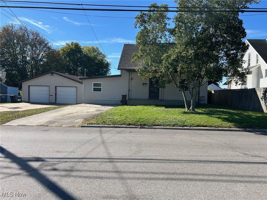 Charming Move-In Ready Home on a Double Lot! This spacious 4-bedroom, 1-bath home sits on a beautiful double lot featuring a large, flat backyard—perfect for outdoor activities. The yard is enclosed with chain-link fencing and includes a spacious back deck, covered front porch, and plenty of off-street parking. An oversized 2-car garage provides ample room for vehicles, storage, or hobbies. Inside, you’ll find a bright and inviting living room with engineered hardwood flooring. The kitchen offers an abundance of cabinetry and opens to a generous dining area with direct access to the back deck and garage—ideal for entertaining. A large first-floor laundry room adds convenience, along with two main-level bedrooms and a beautifully remodeled full bath. Upstairs, you’ll find two additional bedrooms, one featuring an oversized walk-in closet, plus an extra area perfect for an office, playroom, or reading nook. Updates include a roof less than 2 years old, new furnace (2025), new water heater, new flooring throughout, and a completely remodeled bathroom. Conveniently located near the city park, schools, and all amenities.