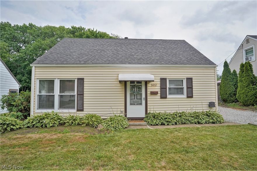 Sparkling clean with neutral paint and furnishings throughout- this Cuyahoga Falls cape is ready for you to make your own! 4 bedrooms- 2 on main floor and 2 upstairs. HUGE, detached garage (w/ its own electric panel) perfect for extra storage or to accommodate your hobbies. You'll love the covered patio off the kitchen that overlooks the COMPLETELY fenced, sizable backyard. Beautiful treed, park-like setting. Kitchen, with hardwood flooring, comes with range, refrigerator and dishwasher that all convey to buyer. Convenient, 1st floor laundry. Vinyl, double-hung windows throughout. The light that streams in through the large living room corner windows will make you feel right at home!  Roof on home and garage both 2014. Hot water tank 2022. Quiet neighborhood with sidewalk-lined streets. Affordable Cuyahoga Falls utilities, adorable community, and nearby parks, recreation (Waterworks!), shopping & expressways. Welcome home!