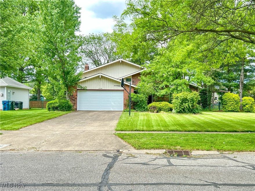 Entering through the beautiful double French doors will bring you to the high-vaulted ceilings of the main floor of this split-level home. The kitchen and dining room are nearby for hosting and entertaining. On the lower level, another large family room is present with a grand fireplace and brick wall. The laundry room, half bath and one of the four bedrooms are also present on this level. The remaining two bedrooms and two full bathrooms are located on the second floor. The spacious master bedroom on the second floor includes double closets along with the attached full bathroom. On the outside of the home, you'll find a beautifully maintained lawn with diverse landscaping and a large backyard perfect for gatherings. The extra-long driveway allows for ample parking outside of the attached 2-car garage.