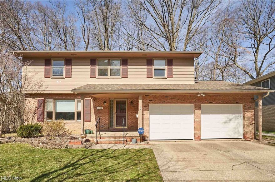 Best views in town all year round!  Stunning park views from this updated 4 bedroom, 2.5 bath West Akron Colonial. Very spacious including 2,136 square feet PLUS additional space in basement Rec Room. Refinished hardwood floors (2020/2023), freshly painted interior and more! Formal Living Room and Dining Rooms, NEW Kitchen with generous island (2020), LVT, new MFS Supply cabinets, quartzite countertops, and stainless appliances. Cozy Family Room with wood-burning fireplace and sliders to patio. Half bath. Upstairs are 4 bedrooms including spacious primary suite with en suite bath. Nice closet space in all bedrooms.  Newly refinished hardwood floors throughout 2nd floor. Walk-in Linen closet. Updated lower level Rec Room (2021), new patio (2021) and shed (2020).  Spacious garage with new insulated garage doors and storage shelves. Cul-de-sac street. Truly unique and stunning setting. Move-in ready! See complete list of updates/ages in supplements.