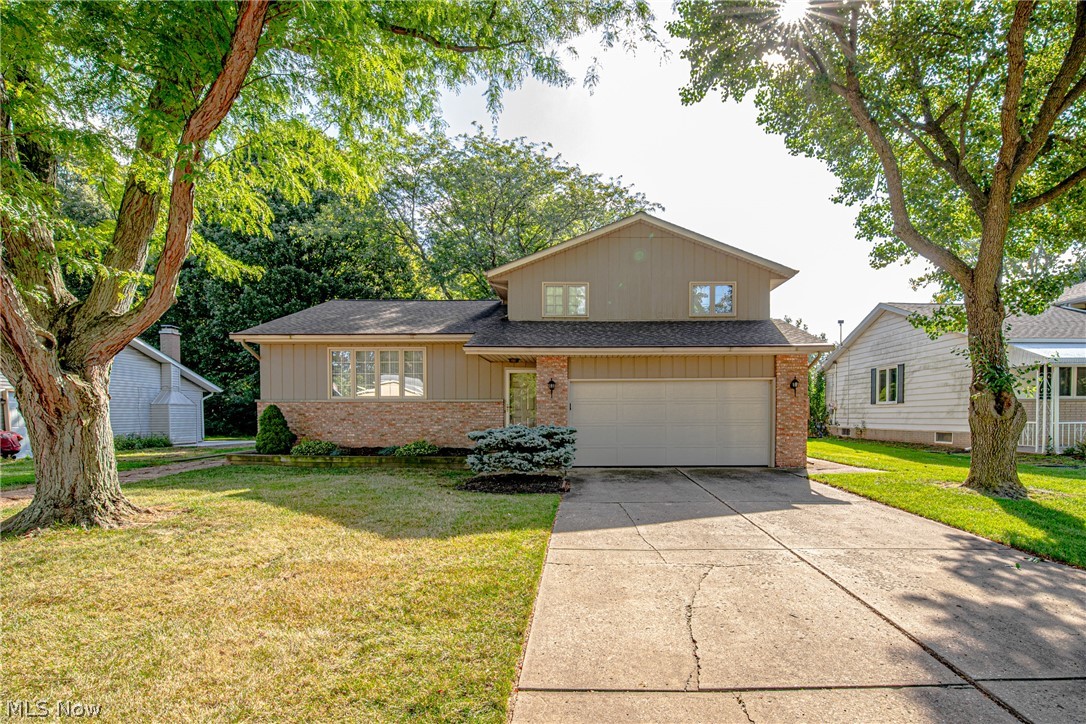Charming split level home sits on a wooded lot in Amherst school district. This house has so much to offer! Great curb appeal. Improvements include: Roof, Bath Fitter tub, gutter covers, backup sump pump, one new Pella casement window in the dining room. There is a large light filled living room and dining room off the foyer. In the kitchen you will find a newer refrigerator and newer oven with plenty of cabinet space. The great room has a full wall brick wood burning fireplace with large window letting in plenty of natural lighting. 3 large size bedrooms on the second floor with spacious closets. The partially finished basement provides amazing recreational room with washer and dryer included. Paved walkway leads you from the driveway to the concrete patio in the partially fenced in backyard that boasts a nice size shed for additional storage! Quick highway and local shopping access.