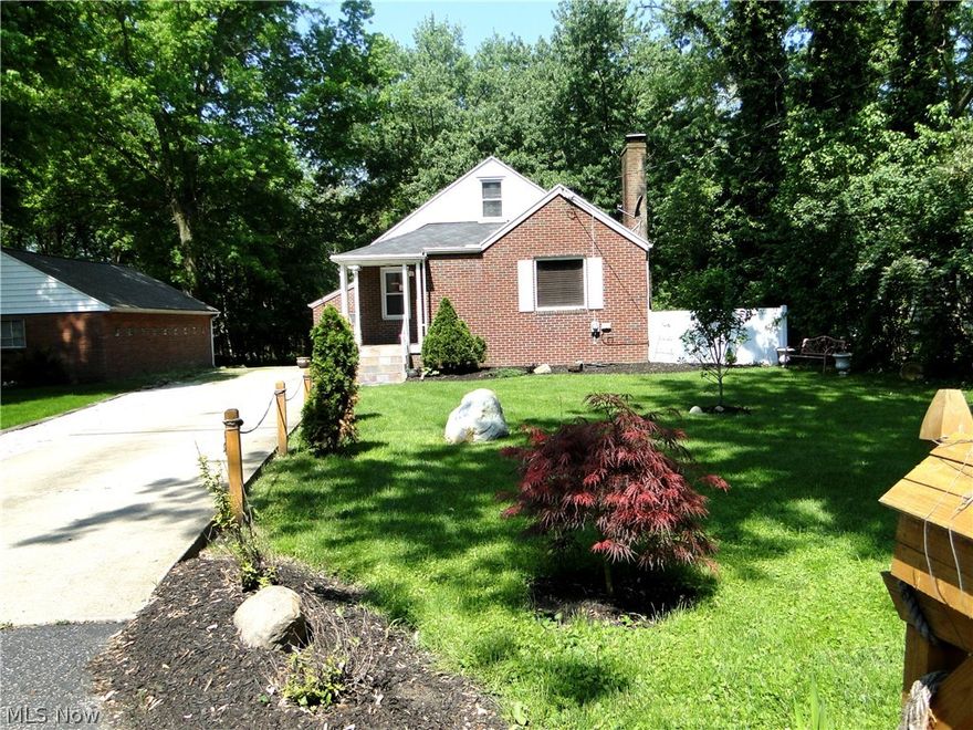 Almost 3/4 of an acre of privacy only minutes from retail establishments and highways. 3 BR/1 BA brick bungalow featuring 1 car and 2 car detached garages. Private deck overlooking treed backyard with a small ornamental fish pond. Compact kitchen with appliances included. Living room features newer laminate flooring. Gas fireplace has been sealed shut and never used by this owner, but is available. Dining room also has newer laminate flooring and has an arched doorway into the kitchen. 2 bedrooms and a full bath on main floor and an 11 x 16 bedroom on upper level features wood flooring. Updates:  2011 roof, plumbing 2010, radon mitigation 2014, hot water tank 2017. Dominion Gas $100, Electric $137, Water/Sewer $63. Chickens can remain or seller will find them a new home. TV, washer and dryer negotiable for purchase.