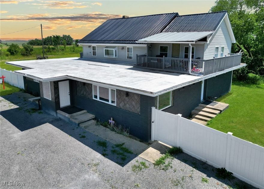 Welcome to this expansive 4,000 sq ft home nestled on 3.05 private acres, offering beautifully updated interiors and flexible dual living spaces ideal for multi-generational living or extended guests. A brand new metal roof was recently installed, adding to the curb appeal. The main level features 3 spacious bedrooms and 2 full bathrooms, heated flooring throughout, along with a generous open-concept layout that includes a large kitchen, dining area, and rec room. The main kitchen has been fully updated with custom cabinetry, granite countertops, and a high-end commercial gas stove, walk-in commercial cooler making it a true centerpiece for entertaining and everyday living. A first-floor laundry adds convenience, while the sunroom provides a peaceful spot to relax and enjoy views of the surrounding property. Upstairs offers a full second living area, complete with its own kitchen, full bathroom, dining room, and a vaulted-ceiling living room. Walk-out access leads to a private covered terrace, creating a perfect retreat or guest suite. Both full bathrooms have been tastefully updated with modern finishes. The property also includes a second parcel equipped with its own septic system, offering additional value and future flexibility. This unique home delivers space, style, and versatility in a tranquil, private setting.