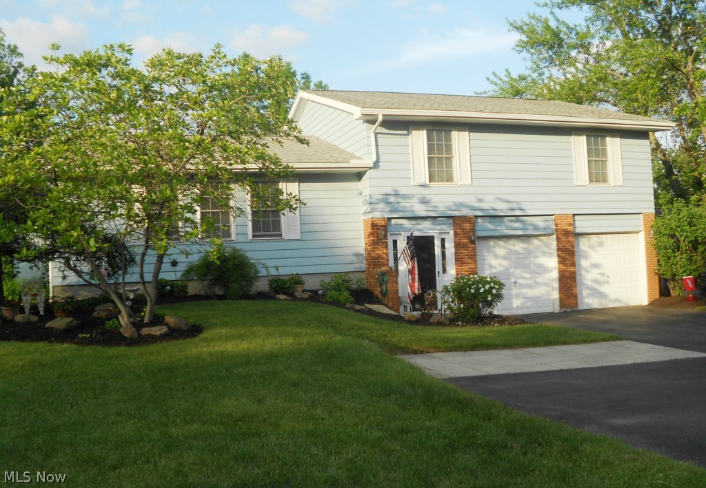 Sharp 4 Level Split offers 4 bedrooms & 2.5 updated baths. This home has a spacious & inviting foyer to greet your family & friends. The lovely kitchen features granite countertops, white cabinets & door to an upper level deck. The formal living room & dining room have lots of natural light, plus there is a family room with sliders to the patio for additional room to entertain. A large master bedroom offers two closets (1 is walk-in) & a master bath. There are ceiling fans and ample closet space in all 4 bedrooms. The basement is separated into 3 areas to be used as you wish (the current owners have a rec room, bonus room & workshop in the basement). Driveway features extra pad for additional parking or turn around for easy access to street. Updates include newer roof, gutters, furnace/AC, electric panel, garage disposal, & windows.