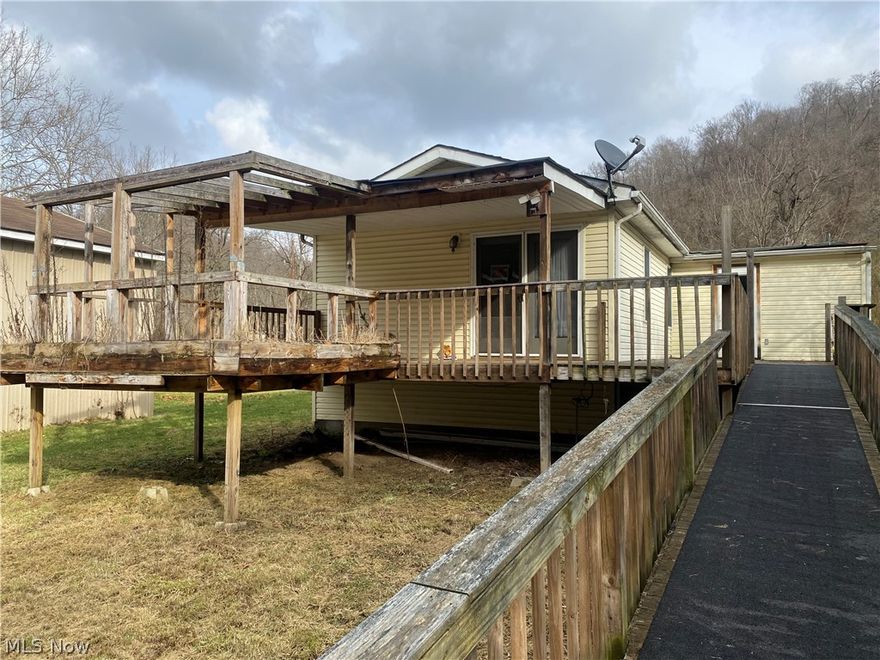 One story ranch with 3 bedrooms, 2 full baths, huge family room with propane fireplace.   Level lot with small creek running along the back.  Huge outbuilding that looked to be a garage at one time...  more of a work shop now but could be a garage again...  clean move in ready.