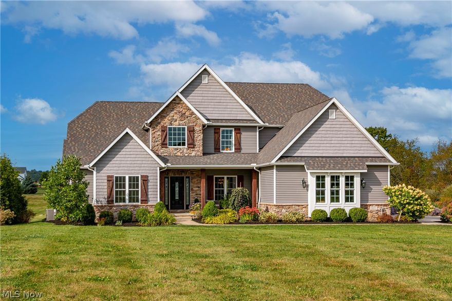 Built by Legacy Homes of Medina in 2016, this former Parade of Homes model is located in sought-after Harp's Mill. Graciously appointed, you will find custom upgrades throughout the open floor plan incl. gourmet appliances, artisan-inspired custom lighting,  custom millwork, reclaimed barn timbers & more.  The great room features a stone fireplace with a locally sourced Amish barn timber mantle, a statement ceiling fan, and bespoke barn doors concealing the wall-mounted TV.  The formal dining room features custom millwork and is flanked by a formal living room/office area.  The kitchen is appointed with every convenience, inc. stainless steel appliances, granite countertops, whole house water filtration system and water softener.  A large eating area with vaulted ceilings and timber details opens to a covered deck overlooking the back yard, patio with w/infinity edge, pond and neighboring farm.  Custom cabinets with soft close, large walk-in pantry and more.  Mudroom with custom built-