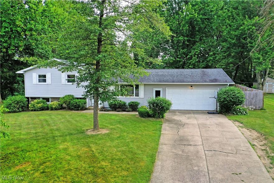 Located on a cul du sac, this 3 bedroom split level home in Austintown is sure to please! Welcome to 60 Woodleigh Ct. The light filled living room with brand new (July 2025) wood look luxury vinyl flooring welcomes you in. Steps away is the kitchen which showcases gorgeous green cabinetry, plenty of counter space to make meal prep a breeze, and appliances to remain. The upper level plays host to 3 generously sized bedrooms with ample closet space and a spacious full bath. Head down to the lower level to hangout in the vintage family room with a beautiful fireplace. Around the corner you will find a cozy home office and additional back yard access. Continue down to the basement for more opportunity for additional living space, storage, home gym, or whatever you can think up! This level also features laundry services, an additional bath, and mechanicals. Make your way to the huge, fenced in backyard and relax on the covered patio! A mulched play area joins multiple seating areas and a chicken coop to make sure everyone in the family has something to do in the private space. What are you waiting for? Call today for your personal tour!