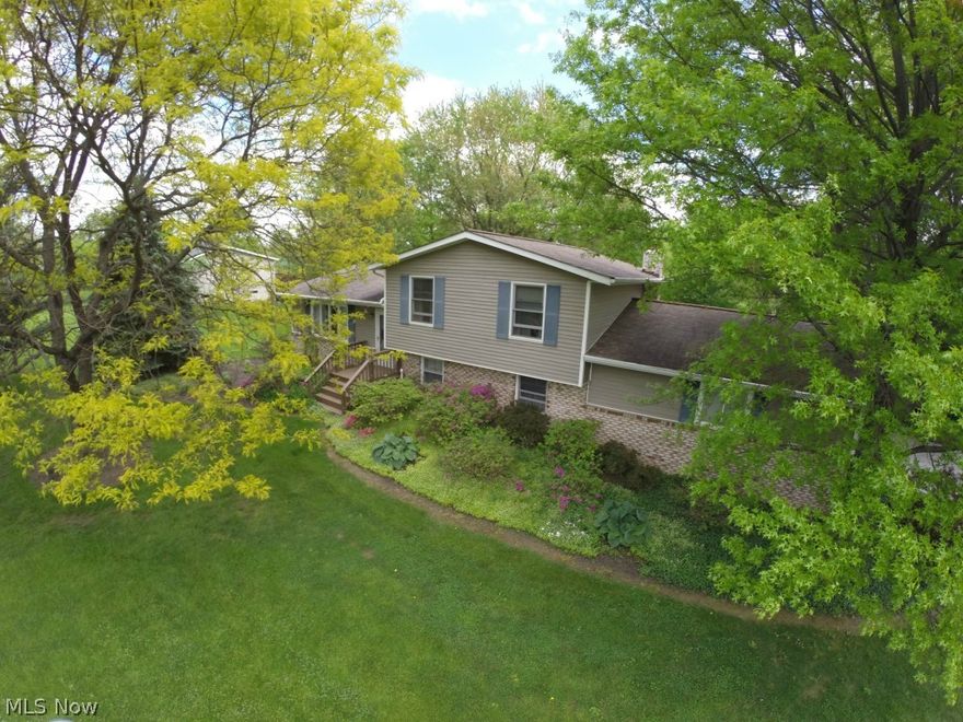 Beautiful light-filled 4-level split nestled on a park-like 2.45 acre setting and surrounded by gorgeous landscape & mature trees. Airy and open living and dining room, updated eat in kitchen w/ Kemper 42” white Ash Cabinets, Corian countertops and all kitchen appliances. First floor private owner’s retreat with full bath and vaulted ceilings with walk out access to a deck with gorgeous views! 3 bedrooms and full bath on the second floor. Lower level features a roomy family room with gas fireplace, laminate flooring, full bathroom and garage access. Lowest level features laundry, large open unfinished basement with workshop area and walk out access. Roof @ 14yr, H20 2014, updated windows, C/A @12 yrs, owner’s suite addition 2000, water softener 2013.