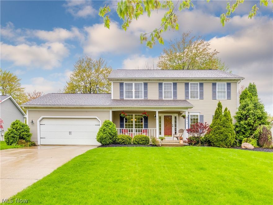 What I love is that from the minute you step onto the inviting front porch, you feel at home!  This spacious 4 bedroom, 2 ½ bath Colonial has over 2400 sq ft of living with a welcoming foyer that leads you to the office (or could be formal living room) and dining room, all with beautiful engineered hardwood flooring and large windows. The eat in kitchen includes an island for extra prep space, updated stainless steel appliances and heated ceramic flooring – and an open concept to the huge family room with a wood burning/gas fireplace.  A convenient first floor laundry and half bath are a plus. Master bedroom has a private bath and large walk in closet. All bedrooms are a great size, ample closet space and large windows with lots of natural light. A newer sliding door leads you to the deck and generous yard. Basement is ready to be finished and includes storage room and utility tub. Garage is extra deep and has dedicated storage area with cabinets & hot/cold water. Updates include Roof