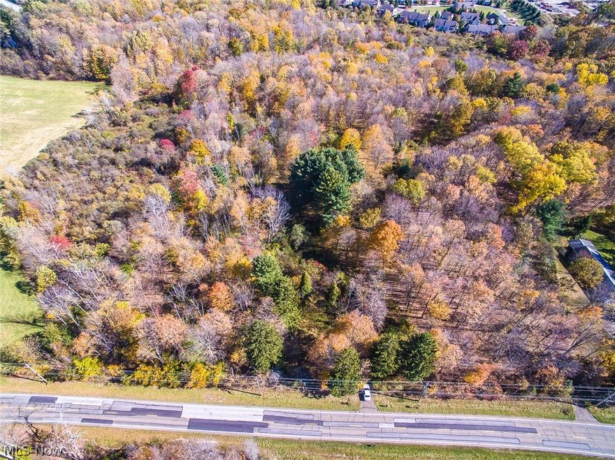 A chance to buy 5 acres in the Kenston School District. Geauga County taxes. Directly across the street from Frohring Meadows Park and less than 5 minutes to the Village of Chagrin Falls.  Mostly wooded lot with a pond and spring/creek near the rear of the property.  Additional 5 acres for sale.  See MLS