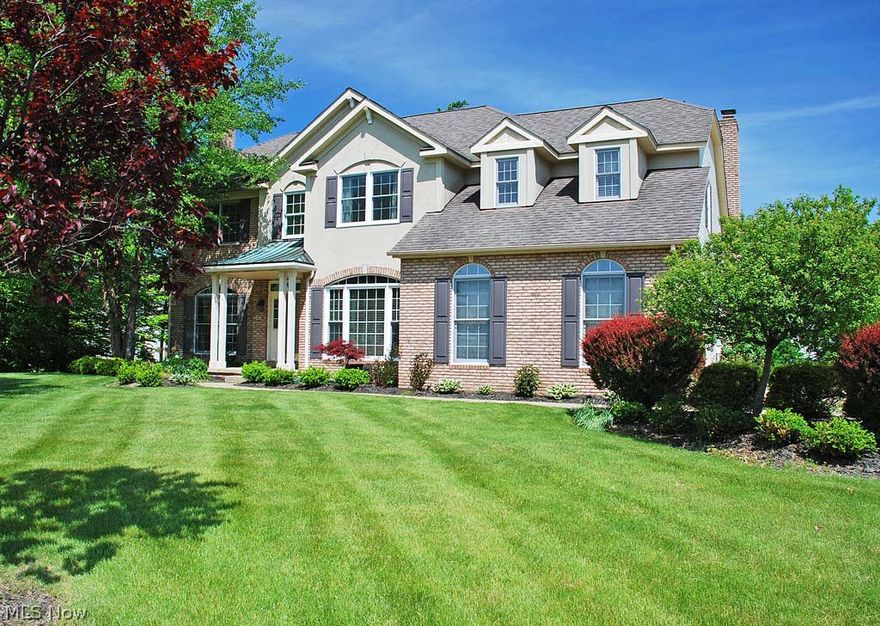 This brick & stucco accented colonial with an inviting portico & oversized arched windows on a fabulous, mature landscaped lot has curb appeal galore. The open floor plan floods this home w/natural light and views of mature trees and landscaping creates pleasing views everywhere in the home.  2-story foyer w/hw floors leads to the formal liv rm, home office and to the white kitchen w/gorgeous granite tops, tiled backsplash, white cabs, and newer appliances. Kitchen opens to the fam rm w/a vaulted ceiling, skylights and a 2nd/back staircase. Mstr br wi/spacious mstr bath with Jacuzzi tub & sep shower. All new (7/2014) carpeting on main and upper levels. The basement is what really sets this home apart – full walkout, generous daylight windows, two large open rooms w/ views of the backyard, newly installed slider to the stamped concrete patio, along with a recently installed full bathroom and partial kitchen. The highly sought after Lakes of Aurora community includes swimming, swim teams