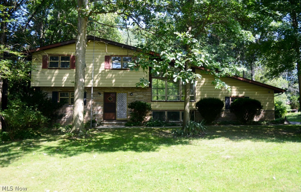 SUBMIT ALL REASONABLE OFFERS! SELLER IS MOTIVATED!! This is not your ordinary Split Level! The vaulted great room with walls of windows on either end of the room with fireplace is stunning! Gleaming hardwood floors in all bedrooms are pristine with little wear. Eat-in kitchen opens to family/hearth room and formal dining room. Lower level is nice spot for a game room and provides access to 2 car rear load garage. Exterior stone accents and secluded back yard nicely shaded by trees with plenty of green space to play round out this beautiful home filled with character. Area rec center and excellent access to shopping, highways and schools make this the home for you!
